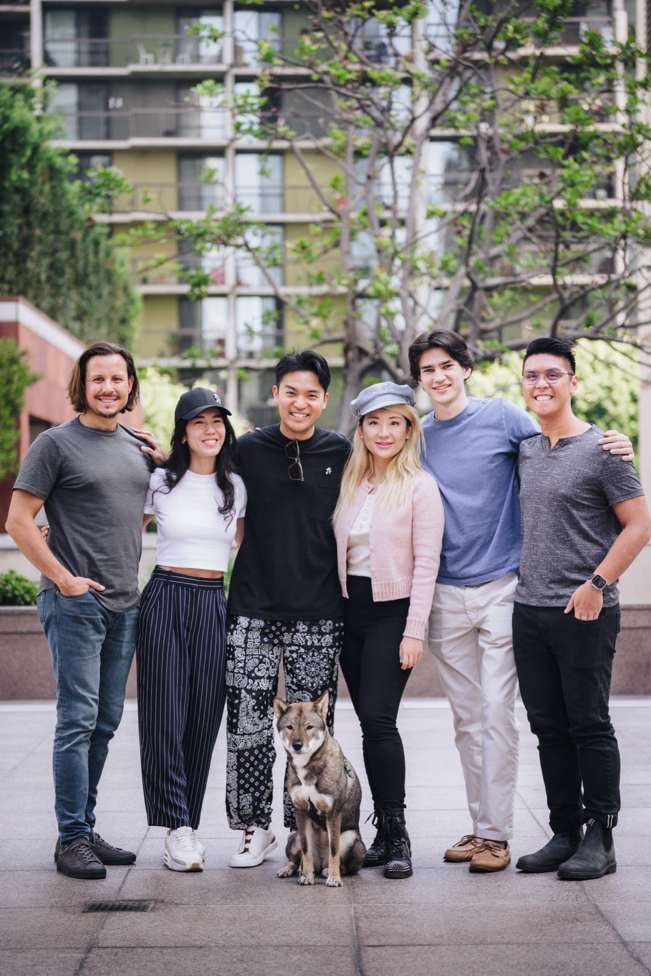 The Tonic team together outdoors, with their dog.